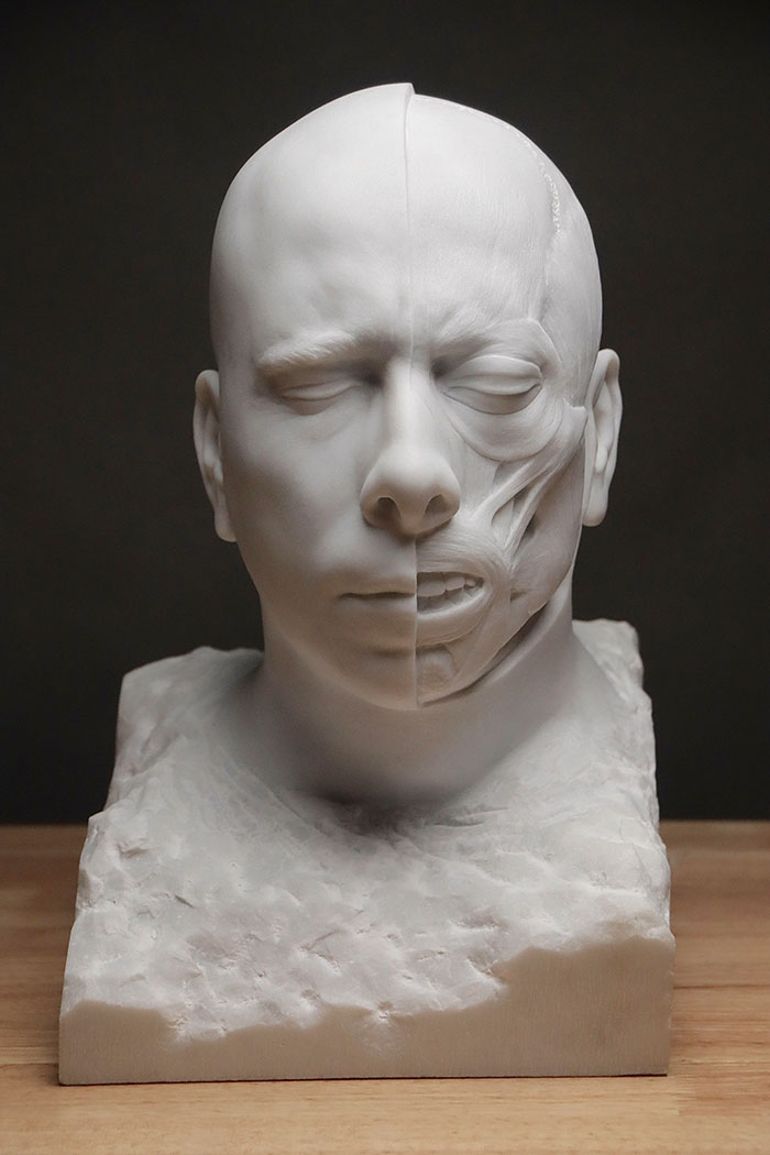 Half-face sculpture showing muscles, a striking example of creepy handmade crafts in marble.