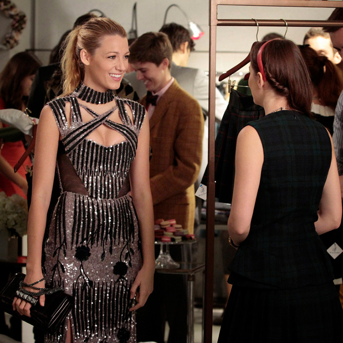 Two women engaged in conversation at a social event, one wearing a sparkling dress. Two women engaged in conversation at a social event, one wearing a sparkling dress.