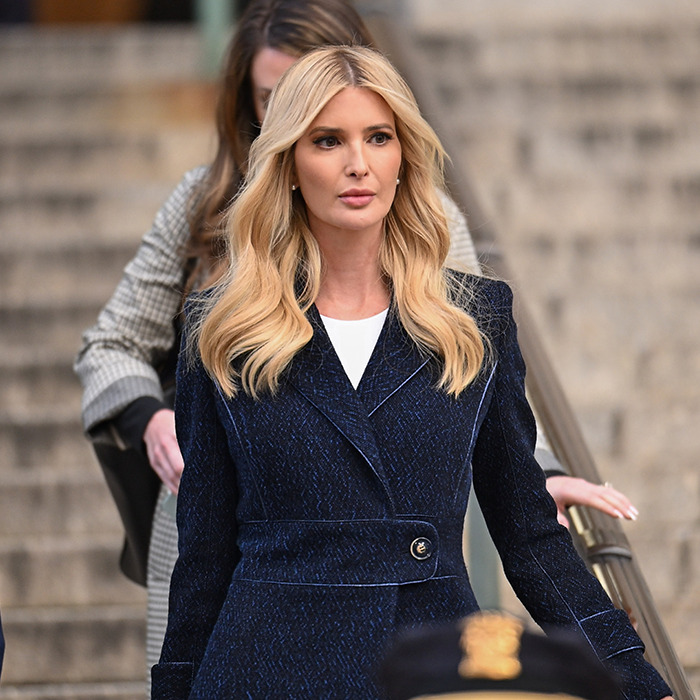 Blonde woman in a navy coat walking down stairs, causing concerns with a recent photo. Blonde woman in a navy coat walking down stairs, causing concerns with a recent photo.