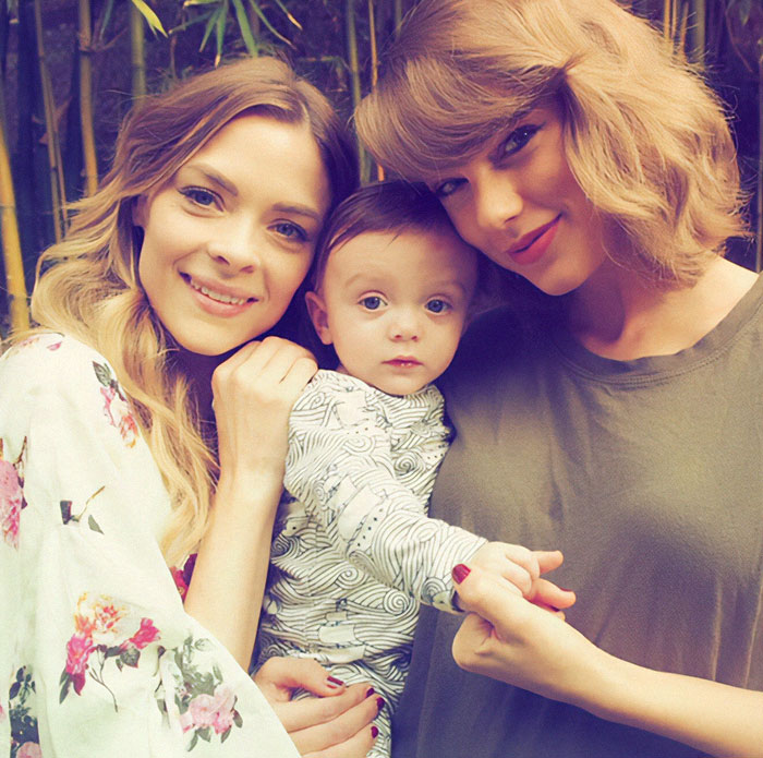 Group photo of two women with a child, focusing on Taylor Swift's godson.