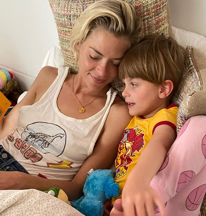 Woman and child smiling in bed, related to Taylor Swift's godson court news.