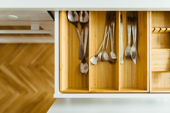 Kitchen drawer with mixed spoons and forks, ideal setup for harmless April Fools’ pranks.