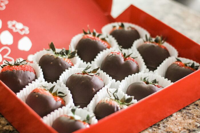 Box of chocolate-covered strawberries, a food some find disgusting despite global enjoyment.