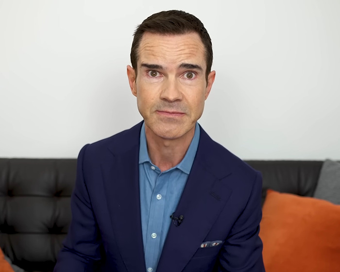 Man in a blue suit sits on a couch, discussing cosmetic "tweakments".