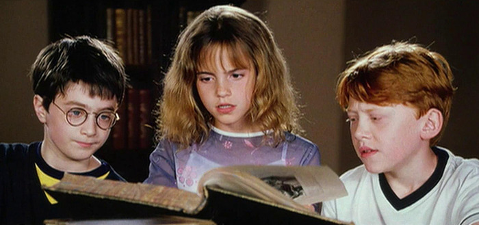 Harry Potter stars reading a large book, sparking outrage in movie fan discussions.