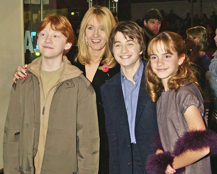 Author with 'Harry Potter' stars, smiling at an event, creating buzz online.