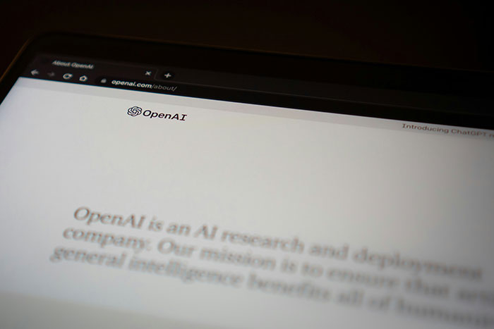 OpenAI webpage displayed on a laptop screen, highlighting AI's impact on the environment.