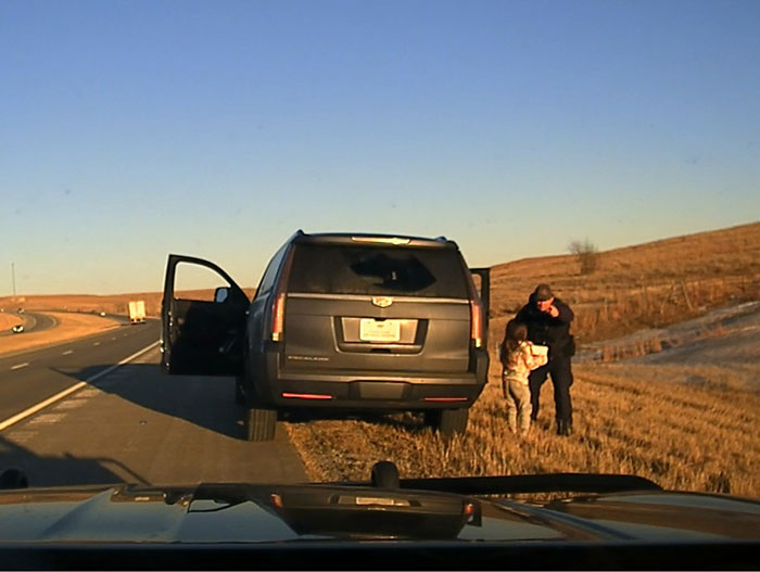 Kansas trooper rescues kidnapped girl next to SUV on roadside during sunset. Kansas trooper rescues kidnapped girl next to SUV on roadside during sunset.
