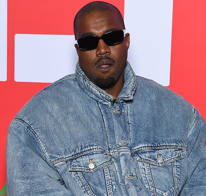 Kanye West in a denim jacket and sunglasses at an event, amid controversy over comments about Beyonc&eacute;'s family.