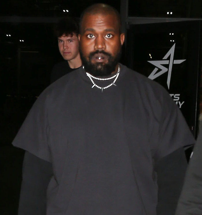 Man in black outfit, wearing a necklace, stands in a dimly lit location, linked to Beyonc&eacute; fans' reaction.