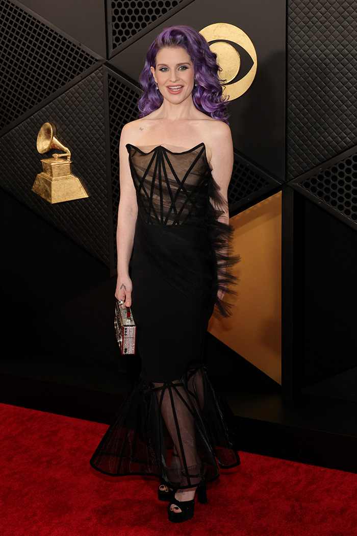 Kelly Osbourne in black dress on red carpet, showcasing dramatic weight loss.