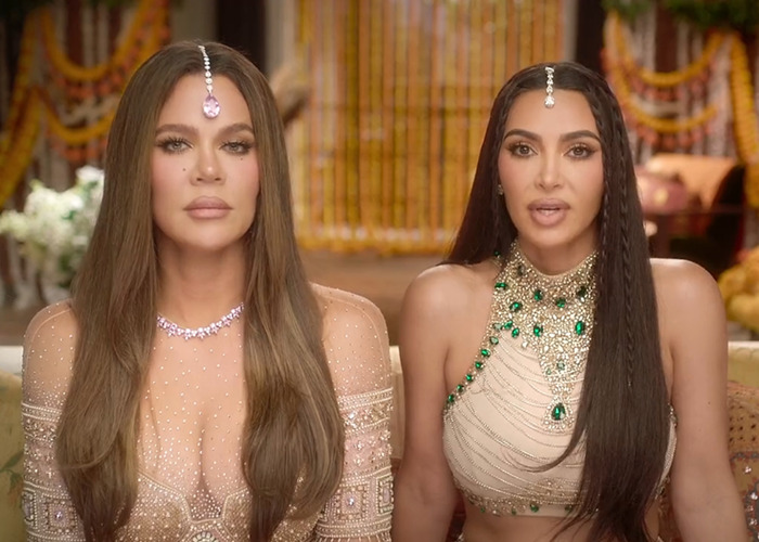 Two women in ornate dresses with head jewelry, sitting side by side, looking at the camera, linked to diamond publicity.