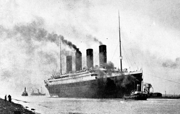 Historic ocean liner emitting smoke from funnels, illustrating last-minute decisions that changed the course of history.