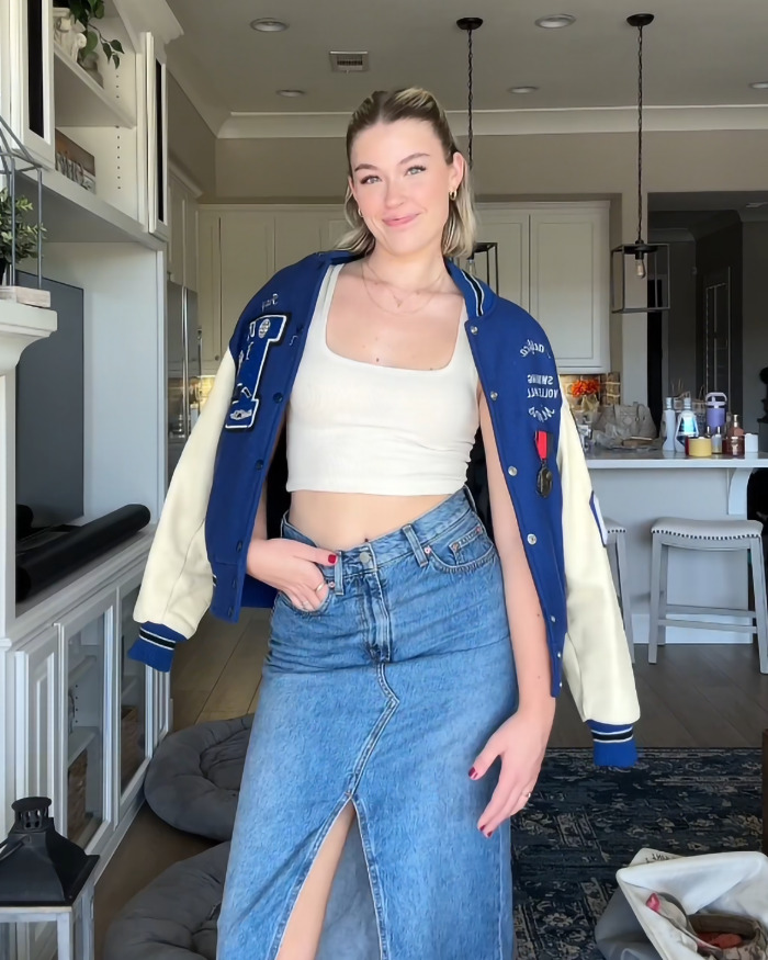 Woman in a trendy outfit with a blue jacket and denim skirt, sparking debate on the "hottest" fashion choice.