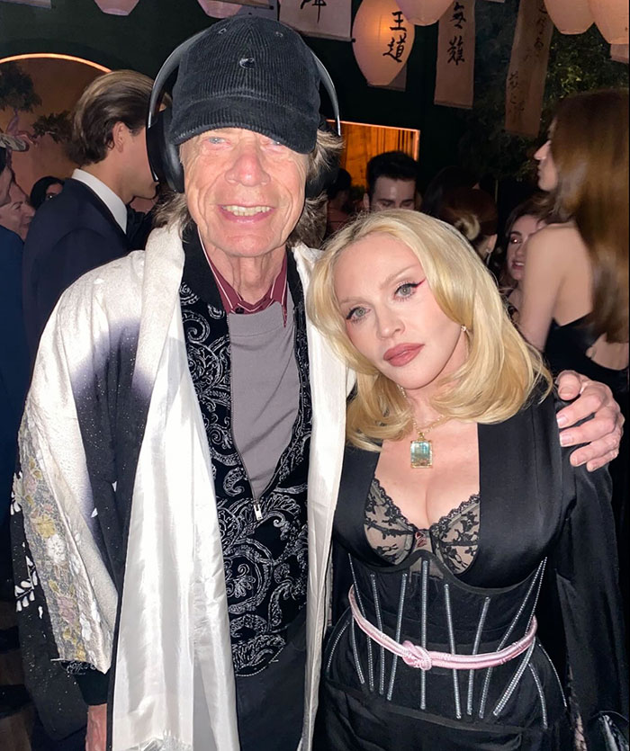 Two people posing together at an event, with a focus on one person's smooth face.