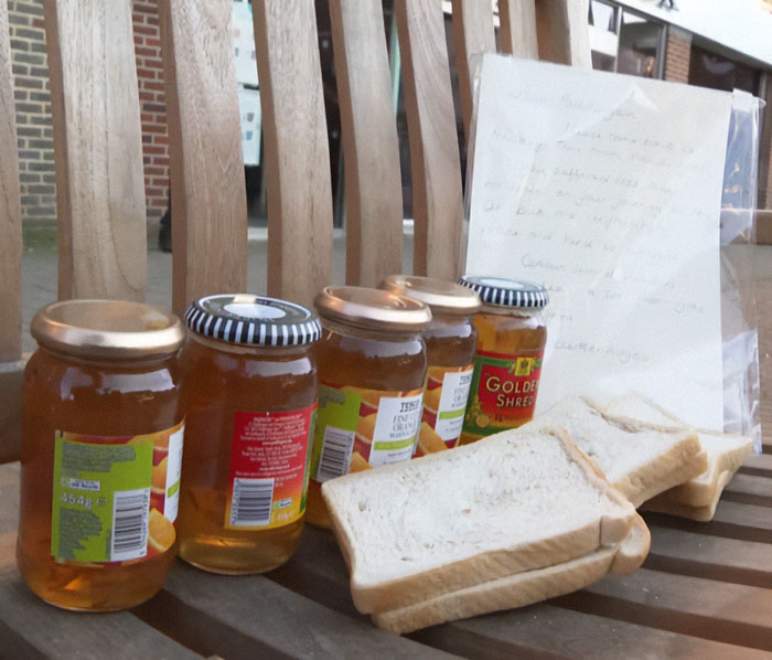 Jars of marmalade and sliced bread on a bench, possibly referencing Paddington Bear.