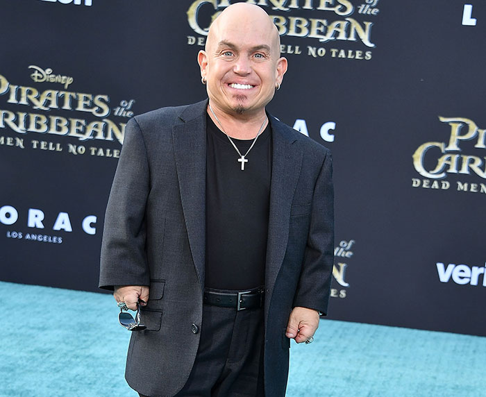 Man in a black suit at a Disney event in Spain, related to the Snow White promotional event.