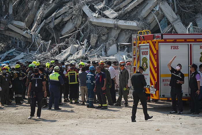 Rescue teams work near collapsed buildings after Myanmar earthquake.