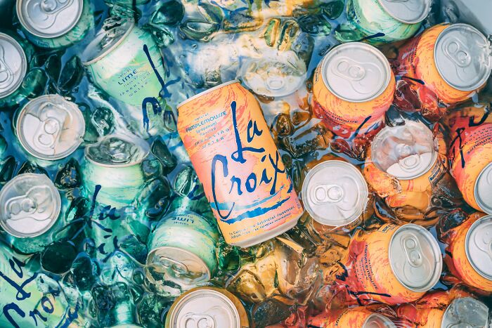 Cans of La Croix sparkling water on ice; some netizens find this food item unfavorable despite global enjoyment.