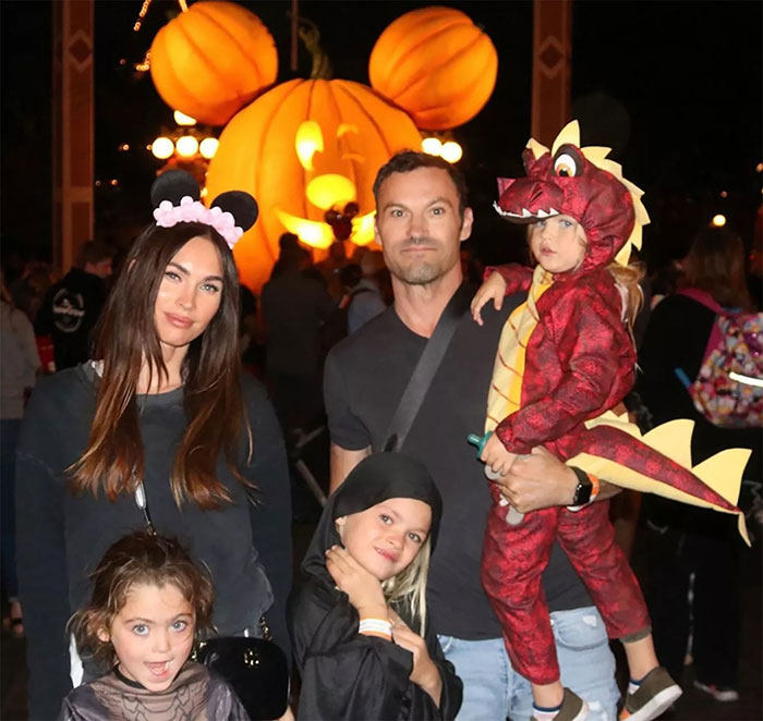Family at a theme park with large pumpkin decoration, related to Celestial Seed discussion.