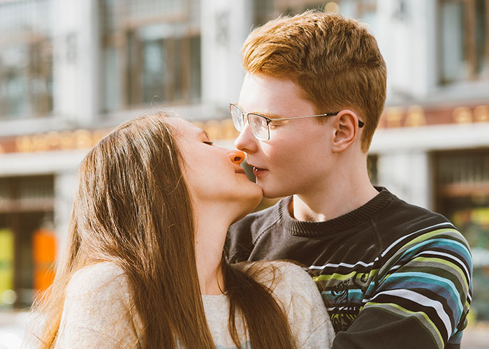A couple embracing outdoors, illustrating questions about men in relationships.