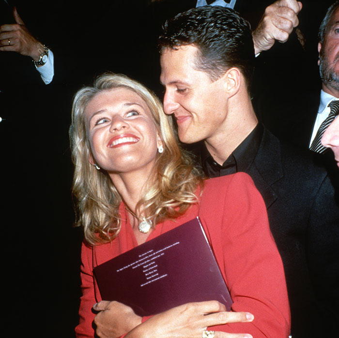 Man and woman smiling together at an event. Main SEO keyword: Michael Schumacher.