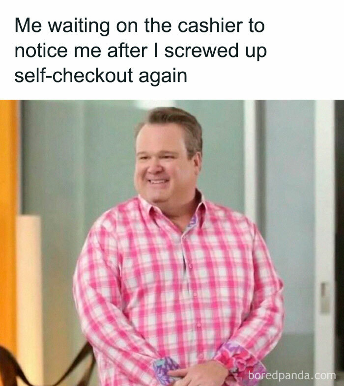 Man in pink plaid shirt smiling, representing a relatable middle-class meme moment about self-checkout struggles.