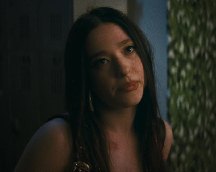 Young woman with long hair, in a thoughtful pose, under subtle lighting, related to "Ride Of A Lifetime.