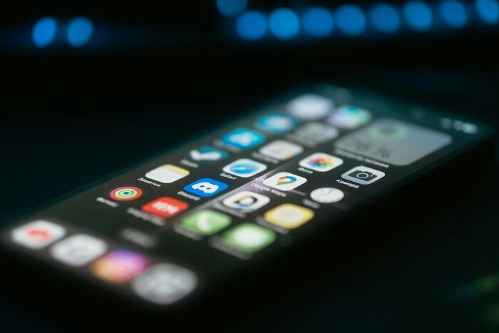 Smartphone apps glowing on screen, symbolizing wild theories in digital media.