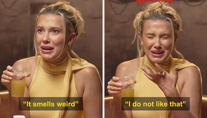 Young woman reacting with displeasure, holding a drink, amid controversial interviews with Brazilians.