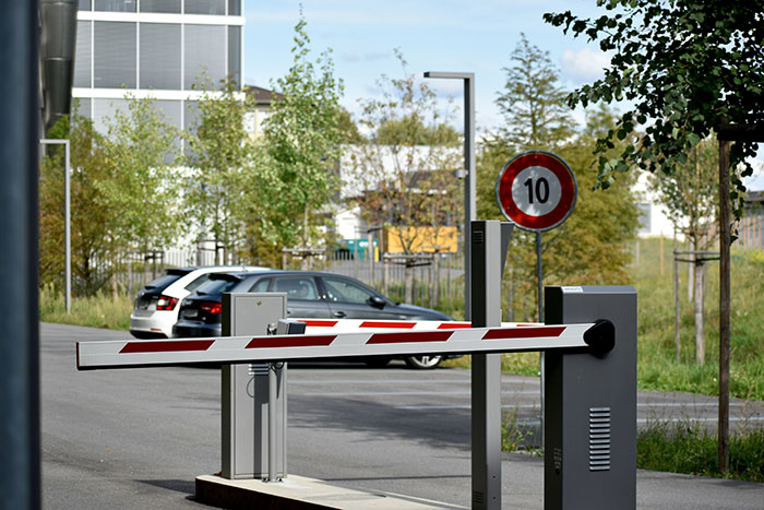 Parking lot with modern gate arm and speed limit sign, showcasing disliked conveniences.
