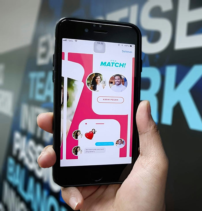 Person holding smartphone with dating app, illustrating modern conveniences.