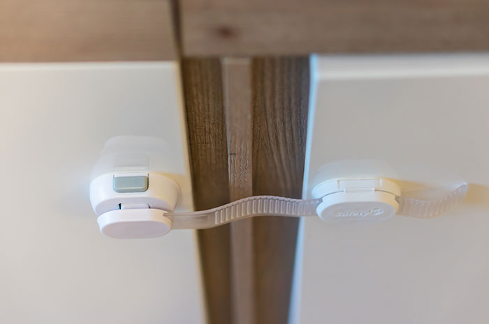 Child lock on a cabinet, representing a modern convenience disliked by some.