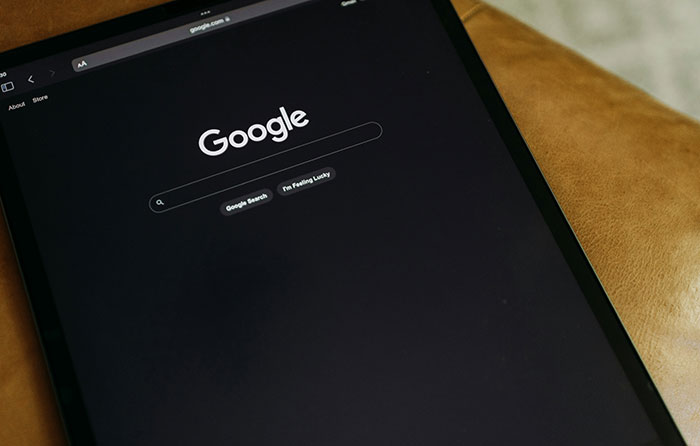 Tablet showing Google search in dark mode, illustrating modern conveniences in technology.