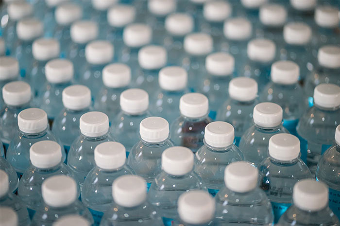 Rows of small plastic water bottles represent a ripoff industry.