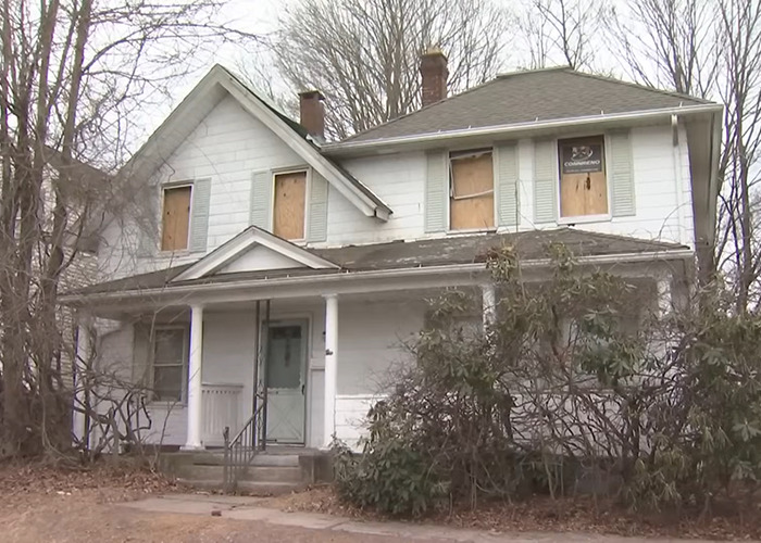 Abandoned house with boarded windows, related to a story involving imprisonment and escape.