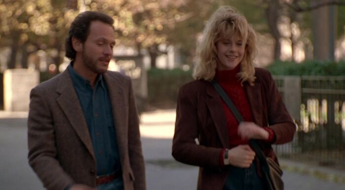 Man and woman walking outdoors, dressed in autumn attire, discussing romantic movie couple names for twins. Man and woman walking outdoors, dressed in autumn attire, discussing romantic movie couple names for twins.