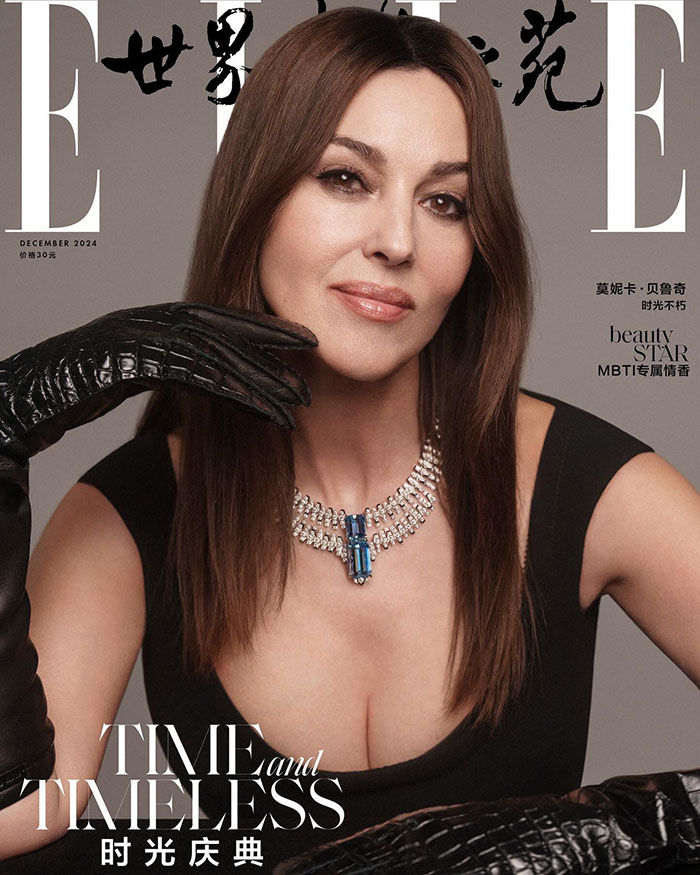 Monica Bellucci on magazine cover, wearing black gloves and a jeweled necklace.