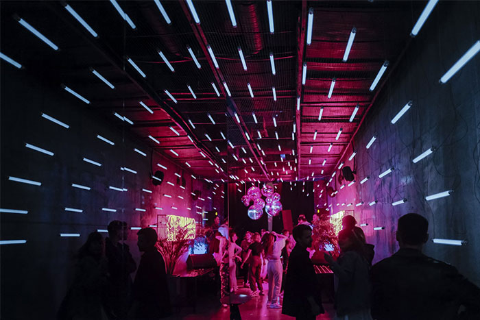 A vibrant, colorful party with neon lights, capturing a memorable coincidence in a lively atmosphere.