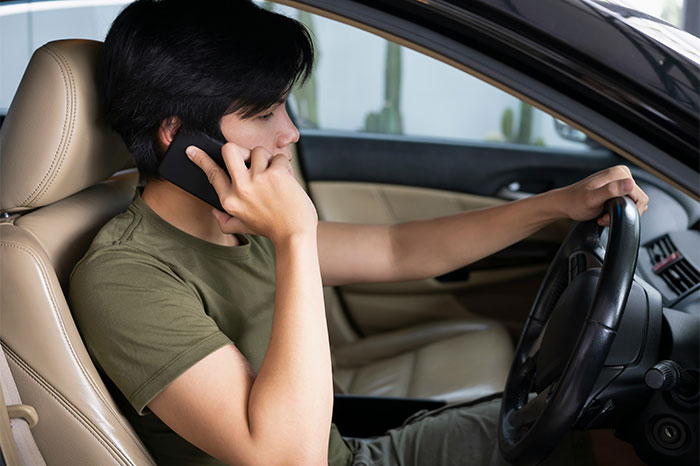 Person talking on phone while driving, illustrating a remarkable coincidence scenario.