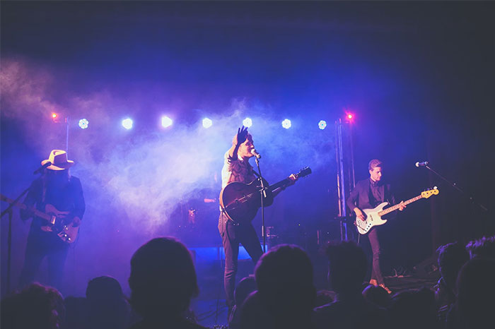 A band performing on stage with vibrant lighting, capturing a memorable coincidence moment.