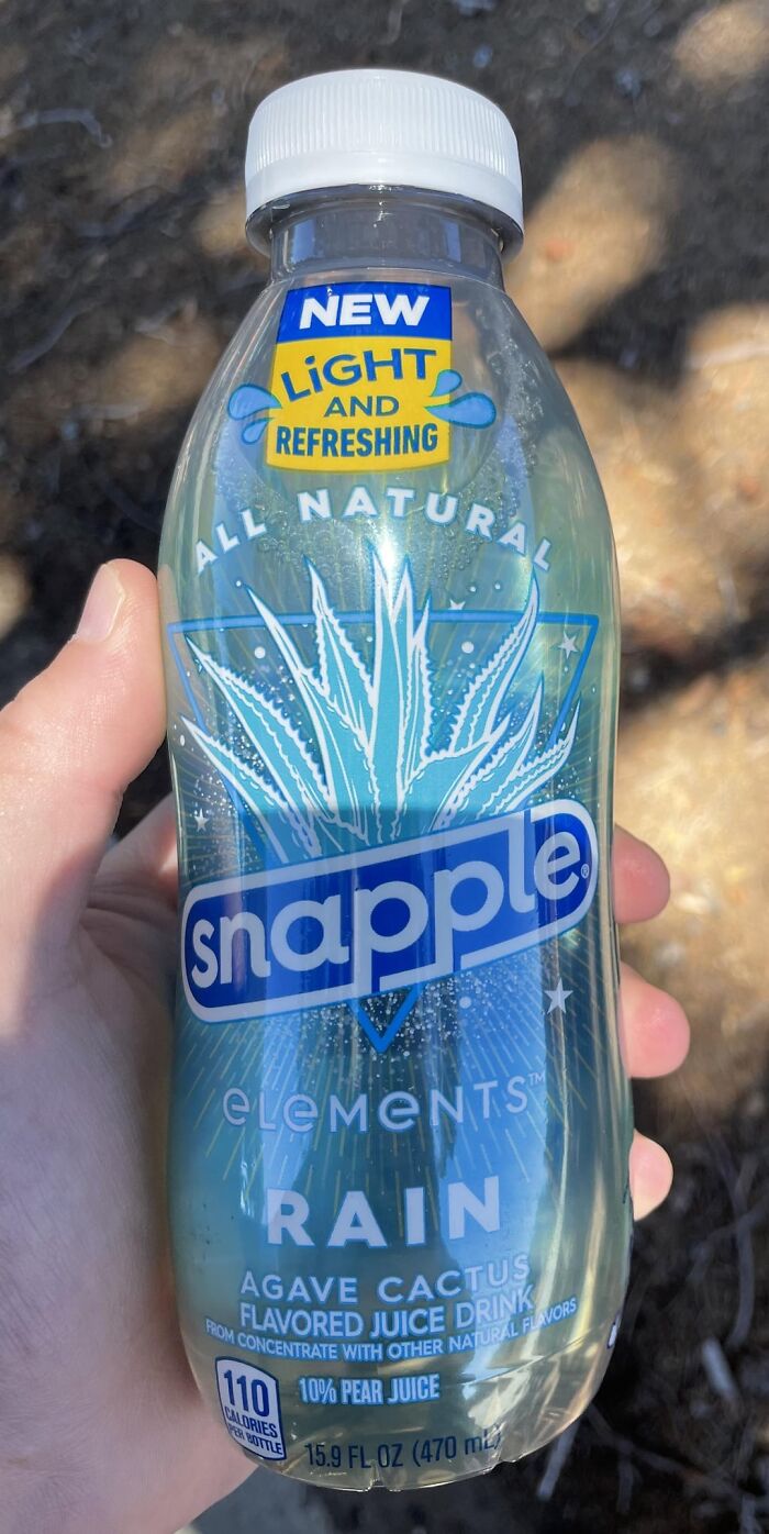 Hand holding a Snapple Elements Rain bottle, a nostalgic discontinued product from the past.
