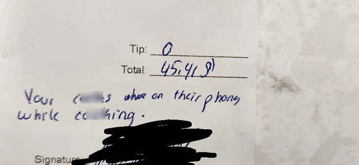 Receipt showing zero server tips with a handwritten complaint about service quality.