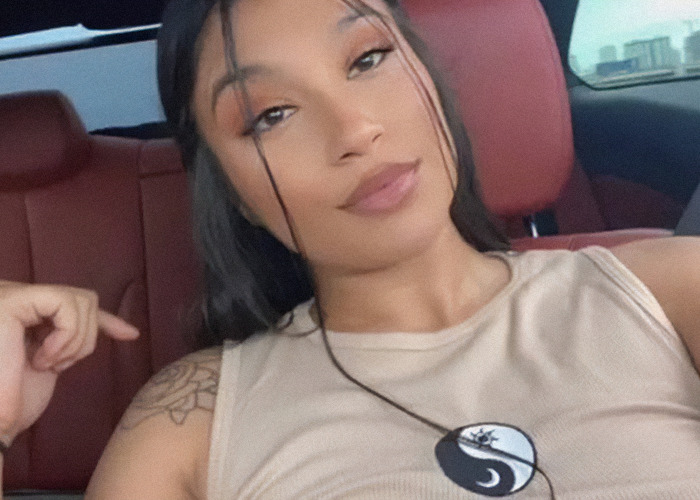 Nahomi Cittadini in a car wearing a yin-yang tank top. Nahomi Cittadini in a car wearing a yin-yang tank top.