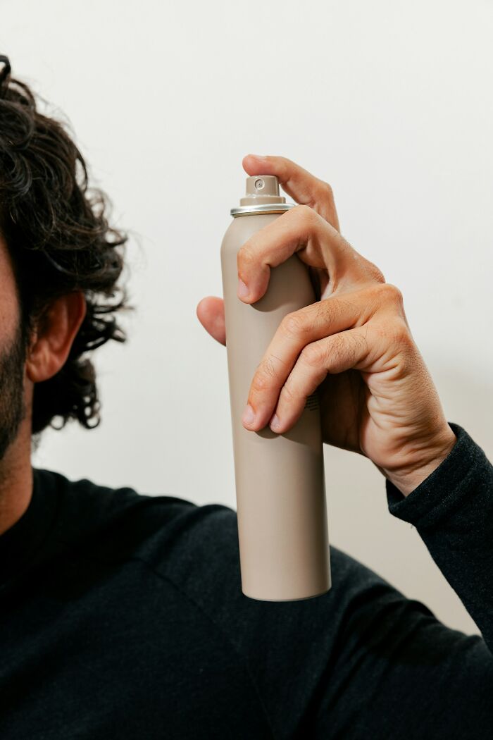 Person holding a spray can, an example of weirdest things doctors removed from a body.