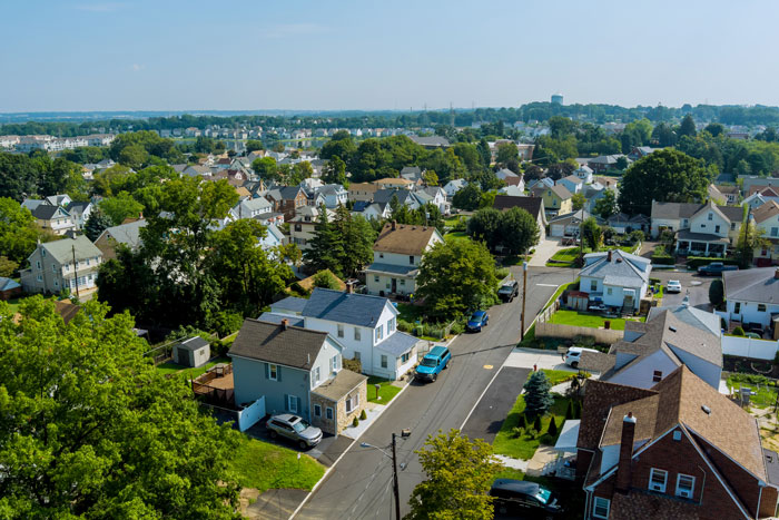 Aerial view of a neighborhood, highlighting houses and streets, reflecting a community setting for a carpool arrangement.