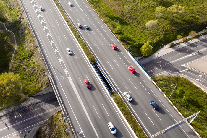 Aerial view of cars on a highway, illustrating a daily carpool agreement concept.