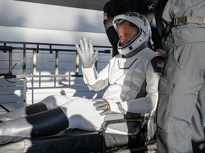 Astronaut being assisted by doctors, raising concerns.