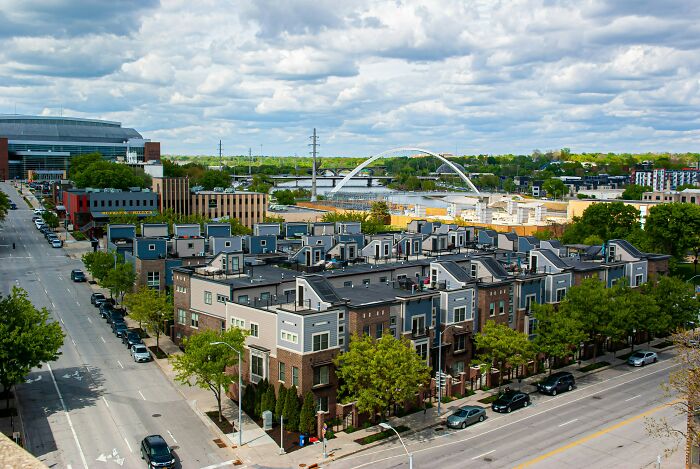 Urban view with modern buildings and a distant bridge, highlighting touristy places not worth the hype according to travelers.