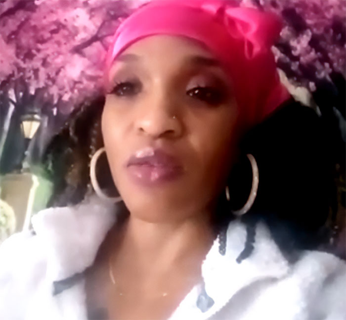 Woman with pink headscarf and hoop earrings in front of floral backdrop, linked to runaway girl found story.